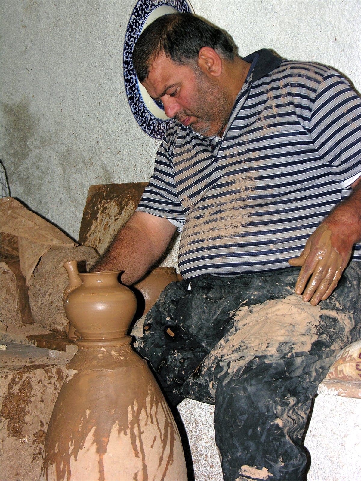 An Avanos master potter at his wheel — the craftspeople our tours visit