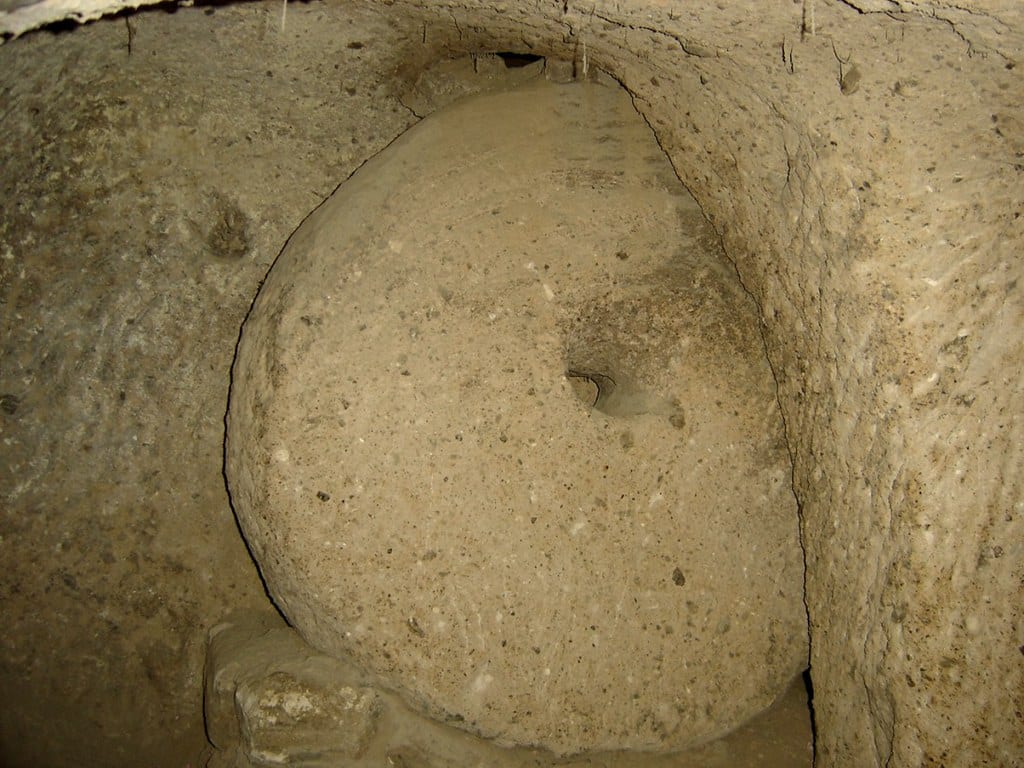 A round millstone door in its carved slot inside a Cappadocian underground city