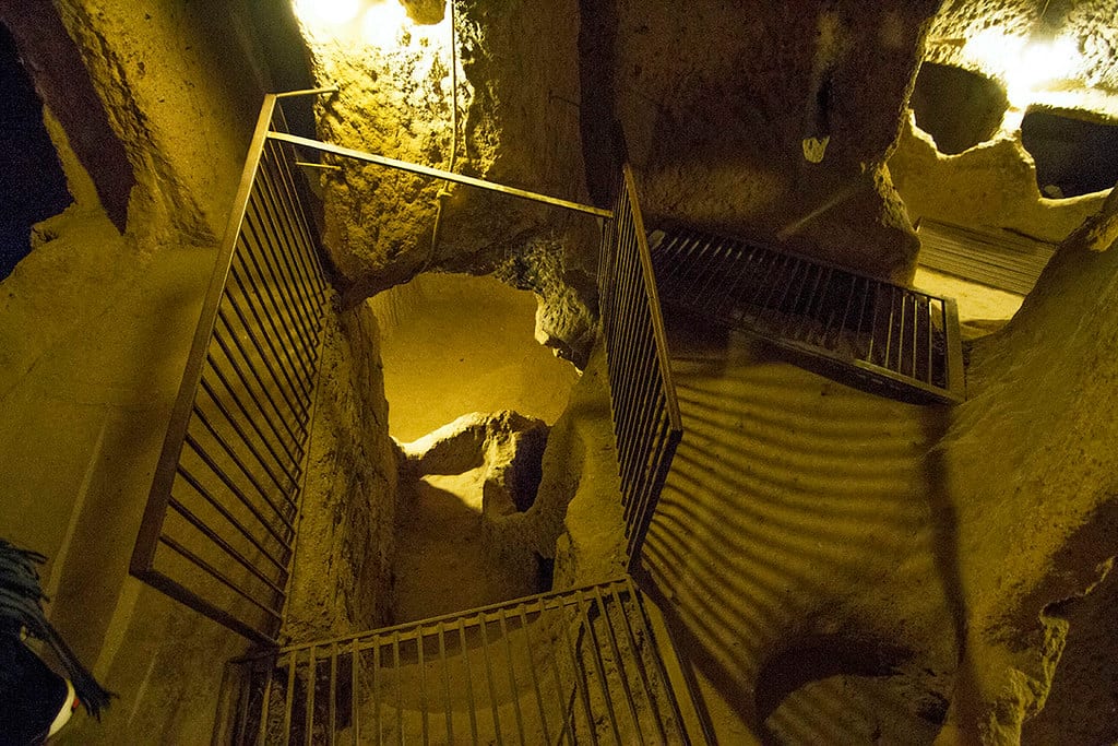 Carved stone stairway descending between levels of Derinkuyu underground city in Turkey